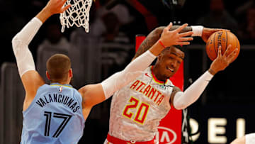 ATLANTA, GEORGIA - MARCH 02: John Collins #20 of the Atlanta Hawks grabs a rebound against Jonas Valanciunas #17 of the Memphis Grizzlies in the first half at State Farm Arena on March 02, 2020 in Atlanta, Georgia. NOTE TO USER: User expressly acknowledges and agrees that, by downloading and/or using this photograph, user is consenting to the terms and conditions of the Getty Images License Agreement. (Photo by Kevin C. Cox/Getty Images)