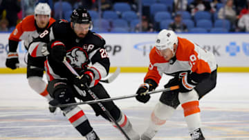 Nov 3, 2023; Buffalo, New York, USA; Buffalo Sabres left wing Zemgus Girgensons (28) and Philadelphia Flyers right wing Cam Atkinson (89) go after a loose puck during the third period at KeyBank Center. Mandatory Credit: Timothy T. Ludwig-USA TODAY Sports
