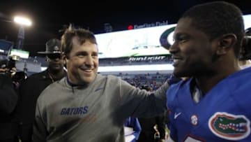 Nov 1, 2014; Jacksonville, FL, USA; Florida Gators head coach Will Muschamp hugs Florida Gators quarterback Treon Harris (3) after they beat the Georgia Bulldogs at EverBank Field. Florida Gators defeated the Georgia Bulldogs 38-20. Mandatory Credit: Kim Klement-USA TODAY Sports