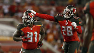 Dec 11, 2016; Tampa, FL, USA; Tampa Bay Buccaneers defensive end Robert Ayers (91) is congratulated by cornerback Vernon Hargreaves (28) after he sacked New Orleans Saints quarterback Drew Brees (9) (not pictured) during the first half at Raymond James Stadium. Mandatory Credit: Kim Klement-USA TODAY Sports