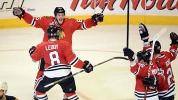 Jun 12, 2013; Chicago, IL, USA; Chicago Blackhawks center Andrew Shaw (65) celebrates with teammates after scoring the game-winning goal against the Boston Bruins during the third overtime period in game one of the 2013 Stanley Cup Final at the United Center. Mandatory Credit: Scott Stewart-USA TODAY Sports