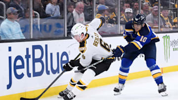 Nov 7, 2022; Boston, Massachusetts, USA; Boston Bruins defenseman Mike Reilly (6) controls the puck away from St. Louis Blues center Brayden Schenn (10) during the second period at TD Garden. Mandatory Credit: Bob DeChiara-USA TODAY Sports