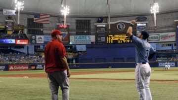 Aug 3, 2014; St. Petersburg, FL, USA; Los Angeles Angels manager Mike Scioscia (14) and Tampa Bay Rays third baseman Evan Longoria (3) look on during a power outage during the third inning at Tropicana Field. Mandatory Credit: Kim Klement-USA TODAY Sports