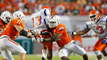 MIAMI GARDENS, FL - SEPTEMBER 21: Al-Quadin Muhammad #98 of the Miami Hurricanes sacks Antonio Bostick #13 of the Savannah State Tigers on September 21, 2013 at Sun Life Stadium in Miami Gardens, Florida. (Photo by Joel Auerbach/Getty Images)