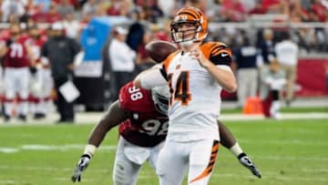 Aug 24, 2014; Glendale, AZ, USA; Cincinnati Bengals quarterback Andy Dalton (14) throws just before being hit by Arizona Cardinals defensive end Frostee Rucker (98) during the first half at University of Phoenix Stadium. Mandatory Credit: Matt Kartozian-USA TODAY Sports