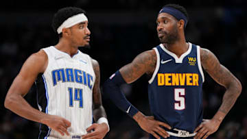 Will Barton #5 of the Denver Nuggets and Gary Harris #14 of the Orlando Magic talk during free throws at Ball Arena on 14 Feb. 2022 in Denver, Colorado. (Photo by Ethan Mito/Clarkson Creative/Getty Images)