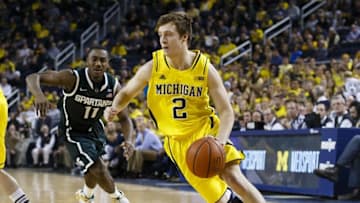 Feb 17, 2015; Ann Arbor, MI, USA; Michigan Wolverines guard Spike Albrecht (2) moves the ball defended past Michigan State Spartans guard Lourawls Nairn Jr. (11) in the first half at Crisler Center. Mandatory Credit: Rick Osentoski-USA TODAY Sports