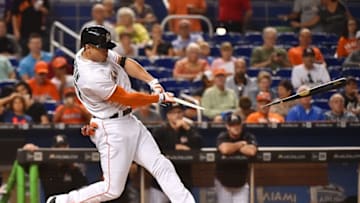 Aug 9, 2016; Miami, FL, USA; Miami Marlins right fielder Giancarlo Stanton (27) breaks his bat on a RBI double in the first inning off of San Francisco Giants starting pitcher Matt Moore (not pictured) at Marlins Park. Mandatory Credit: Jasen Vinlove-USA TODAY Sports