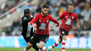 NEWCASTLE UPON TYNE, ENGLAND - DECEMBER 08: Shane Long of Southampton runs with the ball under pressure from Allan Saint-Maximin of Newcastle United during the Premier League match between Newcastle United and Southampton FC at St. James Park on December 08, 2019 in Newcastle upon Tyne, United Kingdom. (Photo by Nigel Roddis/Getty Images)