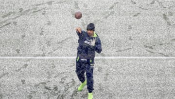 SEATTLE, WASHINGTON - DECEMBER 26: Russell Wilson #3 of the Seattle Seahawks warms up in the snow before the game against the Chicago Bears at Lumen Field on December 26, 2021 in Seattle, Washington. (Photo by Steph Chambers/Getty Images)