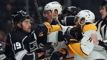 Mar 22, 2022; Los Angeles, California, USA; LA Kings left wing Alex Iafallo (19) and Nashville Predators center Luke Kunin (11) fight during the first period at Crypto.com Arena. Mandatory Credit: Kirby Lee-USA TODAY Sports