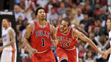 Apr 9, 2015; Miami, FL, USA; Chicago Bulls center Joakim Noah (right) reacts after guard Derrick Rose (left) drives to the basket against the Miami Heat during the second half at American Airlines Arena. Mandatory Credit: Steve Mitchell-USA TODAY Sports