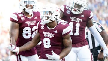 STARKVILLE, MS - SEPTEMBER 21: Running back Kylin Hill #8 celebrates with tight ends Farrod Green #82 and Geor'quarius Spivey #11 of the Mississippi State Bulldogs after scoring a touchdown during the fourth quarter of their game against the Kentucky Wildcats at Davis Wade Stadium on September 21, 2019 in Starkville, Mississippi. (Photo by Michael Chang/Getty Images)