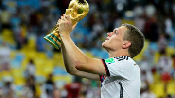 RIO DE JANEIRO, BRAZIL - JULY 13: Matthias Ginter celebrates with the trophy after defeating Argentina 1-0 in extra time during the 2014 FIFA World Cup Brazil Final match between Germany and Argentina at Maracana on July 13, 2014 in Rio de Janeiro, Brazil. (Photo by Matthias Hangst/Getty Images)