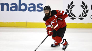 NEWARK, NEW JERSEY - JANUARY 14: Kyle Palmieri #21 of the New Jersey Devils takes the puck in the third period against the Boston Bruins during the home opening game at Prudential Center on January 14, 2021 in Newark, New Jersey. (Photo by Elsa/Getty Images)