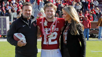 Oklahoma Sooners wide receiver Drake Stoops poses for a photo with his father, former Oklahoma coach Bob Stoops, and his mother, Carol Stoops, during Senior Day before a college football game between the University of Oklahoma Sooners (OU) and the TCU Horned Frogs at Gaylord Family-Oklahoma Memorial Stadium in Norman, Okla., Friday, Nov. 24, 2023. Oklahoma won 69-45.