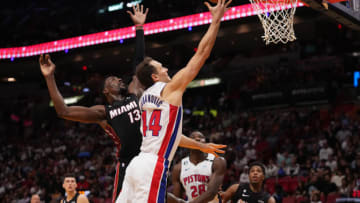 Detroit Pistons forward Bojan Bogdanovic (44) shoots the ball around Miami Heat center Bam Adebayo (13)(Jasen Vinlove-USA TODAY Sports)