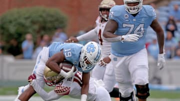 CHAPEL HILL, NORTH CAROLINA - OCTOBER 09: Jammie Robinson #10 of the Florida State Seminoles tackles Ty Chandler #19 of the North Carolina Tar Heels cduring the first half of their game at Kenan Memorial Stadium on October 09, 2021 in Chapel Hill, North Carolina. (Photo by Grant Halverson/Getty Images)