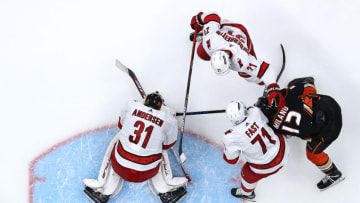 ANAHEIM, CALIFORNIA - NOVEMBER 18: Frederik Andersen #31, Nino Niederreiter #21 and Jesper Fast #71 of the Carolina Hurricanes defend against Sonny Milano #12 of the Anaheim Ducks during the third period of a game at Honda Center on November 18, 2021 in Anaheim, California. (Photo by Sean M. Haffey/Getty Images)