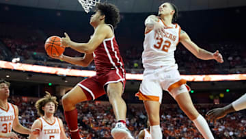Jan 11, 2022; Austin, Texas, USA; Oklahoma Sooners forward Jalen Hill (1) drives to the basket past Texas Longhorns forward Christian Bishop (32) during the second half at Frank C. Erwin Jr. Center. Mandatory Credit: Scott Wachter-USA TODAY Sports