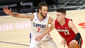 LOS ANGELES, CALIFORNIA - FEBRUARY 15: Tyler Herro #14 of the Miami Heat handles the ball defended by Amir Coffey #7 of the LA Clippers at Staples Center on February 15, 2021 in Los Angeles, California. NOTE TO USER: User expressly acknowledges and agrees that, by downloading and or using this photograph, User is consenting to the terms and conditions of the Getty Images License Agreement. (Photo by Meg Oliphant/Getty Images)