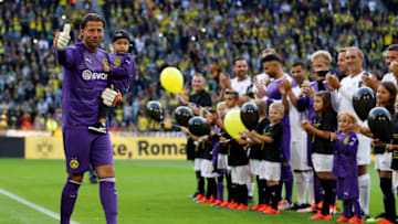 DORTMUND, GERMANY - SEPTEMBER 07: Roman Weidenfeller of Borussia Dortmund Allstars enter the pitch with his son prior to the Roman Weidenfeller Farewell Match between Borussia Dortmund Allstars and Roman and Friends at Signal Iduna Park on September 7, 2018 in Dortmund, Germany. (Photo by Christof Koepsel/Bongarts/Getty Images)