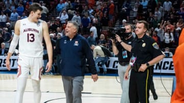Auburn Tigers forward Walker Kessler (13) and head coach Bruce Pearl walk off the court after the game during the first round of the 2022 NCAA tournament at Bon Secours Wellness Arena in Greenville, S.C., on Friday, March 18, 2022. Auburn Tigers defeated Jacksonville State Gamecocks 80-61.