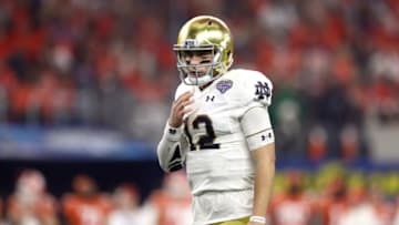 ARLINGTON, TEXAS - DECEMBER 29: Ian Book #12 of the Notre Dame Fighting Irish looks on in the first quarter against the Clemson Tigers during the College Football Playoff Semifinal Goodyear Cotton Bowl Classic at AT&T Stadium on December 29, 2018 in Arlington, Texas. (Photo by Ronald Martinez/Getty Images)