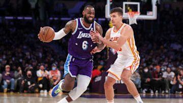 LOS ANGELES, CALIFORNIA - JANUARY 07: LeBron James #6 of the Los Angeles Lakers handles the ball defended by Bogdan Bogdanovic #13 of the Atlanta Hawks in the second half at Crypto.com Arena on January 07, 2022 in Los Angeles, California. NOTE TO USER: User expressly acknowledges and agrees that, by downloading and or using this photograph, User is consenting to the terms and conditions of the Getty Images License Agreement. (Photo by Meg Oliphant/Getty Images)
