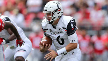 Cincinnati Bearcats quarterback Ben Bryant carries the ball in the fourth quarter. The Enquirer.