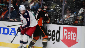 Apr 17, 2022; Anaheim, California, USA; Columbus Blue Jackets center Sean Kuraly (7) plays for the puck against Anaheim Ducks center Adam Henrique (14) during the third period at Honda Center. Mandatory Credit: Gary A. Vasquez-USA TODAY Sports