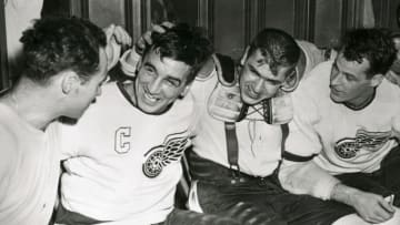 (Original Caption) This Quartet of Detroit Red Wings make merry in their dressing room after they scored the goals that sent the Maple Leafs down to a 5-4 defeat in overtime play. For the Detroiters it meant a 3-0 lead in the semifinals of the National Hockey League Playoffs. Left to right are Red Kelly, Ted Lindsay, Metro Prystiol and Gordie Howe.