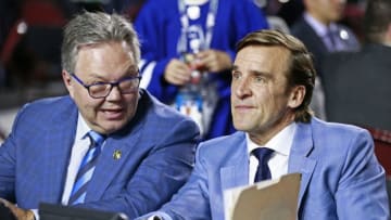 VANCOUVER, BRITISH COLUMBIA - JUNE 21: General manager Kelly McCrimmon (L) and president of hockey operations George McPhee of the Vegas Golden Knights look on from the team draft table during the first round of the 2019 NHL Draft at Rogers Arena on June 21, 2019 in Vancouver, Canada. (Photo by Jeff Vinnick/NHLI via Getty Images)