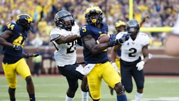 Sep 10, 2016; Ann Arbor, MI, USA; Michigan Wolverines linebacker Jabrill Peppers (5) runs the ball on a punt return in the second quarter against the UCF Knights at Michigan Stadium. Mandatory Credit: Rick Osentoski-USA TODAY Sports