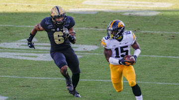 WEST LAFAYETTE, IN - OCTOBER 24: Tyler Goodson #15 of the Iowa Hawkeyes runs the ball after catching a pass as Jalen Graham #6 of the Purdue Boilermakers defends during the first half at Ross-Ade Stadium on October 24, 2020 in West Lafayette, Indiana. (Photo by Michael Hickey/Getty Images)