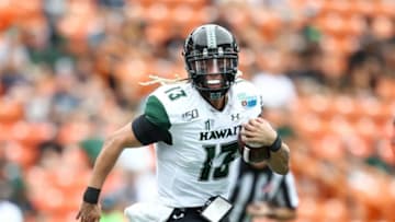 HONOLULU, HI - DECEMBER 24: Cole McDonald #13 of the Hawaii Rainbow Warriors runs the ball during the second quarter against the BYU Cougars of the Hawai'i Bowl at Aloha Stadium on December 24, 2019 in Honolulu, Hawaii. (Photo by Darryl Oumi/Getty Images)