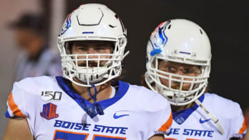 LAS VEGAS, NEVADA - OCTOBER 05: Offensive lineman John Molchon #77 and offensive lineman Garrett Larson #67 of the Boise State Broncos walk on the field for their game against the UNLV Rebels at Sam Boyd Stadium on October 5, 2019 in Las Vegas, Nevada. The Broncos defeated the Rebels 38-13. (Photo by Ethan Miller/Getty Images)