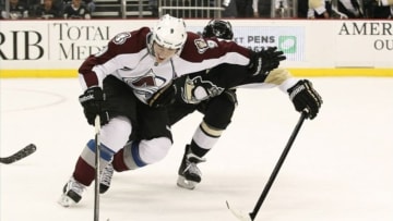 Oct 21, 2013; Pittsburgh, PA, USA; Colorado Avalanche center Matt Duchene (9) wards off Pittsburgh Penguins defenseman Matt Niskanen (2) while handling the puck during the second period at the CONSOL Energy Center. The Colorado Avalanche won 1-0. Mandatory Credit: Charles LeClaire-USA TODAY Sports