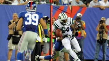Aug 24, 2013; East Rutherford, NJ, USA; New York Jets wide receiver Stephen Hill (84) fumbles the ball after a hit by New York Giants cornerback Trumaine McBride (38) during the fourth quarter of a preseason game at MetLife Stadium. The fumble would be recovered by New York Giants safety Tyler Sash (39). Mandatory Credit: Brad Penner-USA TODAY Sports