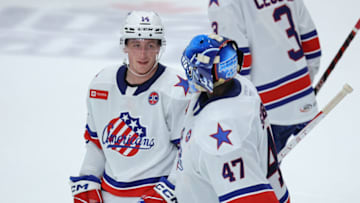 SYRACUSE, NY - APRIL 21: Josh Passolt #14 of Rochester Americans talks to Malcolm Subban #47 of Rochester Americans following the third period against the Syracuse Crunch at Upstate Medical University Arena on April 21, 2023 in Syracuse, New York. (Photo by Isaiah Vazquez/Getty Images)