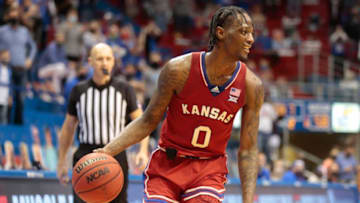 Kansas senior guard Marcus Garrett smiles while holding the ball in the final minute of play against Baylor on Saturday at Allen Fieldhouse. The Jayhawks won 71-58.