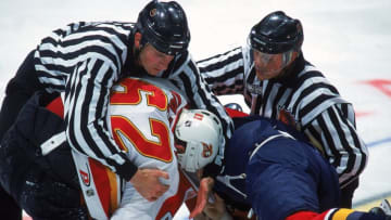 8 Nov 1999: Andrei Nazarov #62 of the Calgary Flames is pulled back from a fight by a referee during a game against the Florida Panthers at the Canadian Airlines Arena in Calgary, Canada. The Panthers defeated the Flames 6-3. Mandatory Credit: Ian Tomlinson /Allsport
