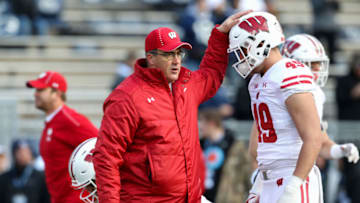 Nov 10, 2018; University Park, PA, USA; Wisconsin Badgers head coach Paul Chryst taps the helmet of tight end Kyle Penniston (49) during a warmup prior to a game against the Penn State Nittany Lions at Beaver Stadium. Mandatory Credit: Matthew O'Haren-USA TODAY Sports