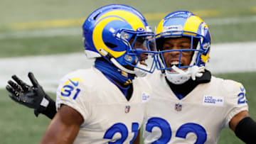 SEATTLE, WASHINGTON - JANUARY 09: Defensive back Darious Williams #31 and Troy Hill #22 of the Los Angeles Rams react after an interception for a touchdown during the second quarter of the NFC Wild Card Playoff game against the Seattle Seahawks at Lumen Field on January 09, 2021 in Seattle, Washington. (Photo by Steph Chambers/Getty Images)