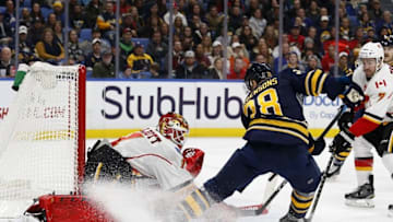 Nov 21, 2016; Buffalo, NY, USA; Calgary Flames goalie Brian Elliott (1) makes a save on Buffalo Sabres center Zemgus Girgensons (28) during the second period at KeyBank Center. Mandatory Credit: Timothy T. Ludwig-USA TODAY Sports