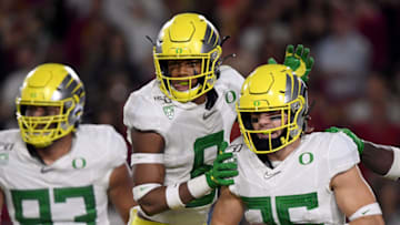 LOS ANGELES, CALIFORNIA - NOVEMBER 02: Brady Breeze #25 of the Oregon Ducks celebrates his touchdown from his interception with Jevon Holland #8 and Sione Kava #93, to take a 21-10 lead over the USC Trojans, during the first half at Los Angeles Memorial Coliseum on November 02, 2019 in Los Angeles, California. (Photo by Harry How/Getty Images)