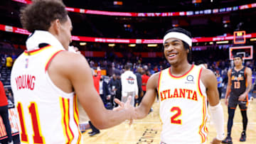 ORLANDO, FLORIDA - DECEMBER 15: Trae Young #11 and Sharife Cooper #2 of the Atlanta Hawks celebrate after defeating the Orlando Magic at Amway Center on December 15, 2021 in Orlando, Florida. NOTE TO USER: User expressly acknowledges and agrees that, by downloading and or using this photograph, User is consenting to the terms and conditions of the Getty Images License Agreement. (Photo by Michael Reaves/Getty Images)