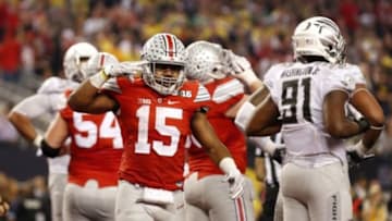 Jan 12, 2015; Arlington, TX, USA; Ohio State Buckeyes running back Ezekiel Elliott (15) reacts after scoring a touchdown against the Oregon Ducks in the second half in the 2015 CFP National Championship Game at AT&T Stadium. Mandatory Credit: Matthew Emmons-USA TODAY Sports