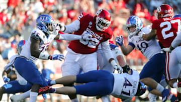 Nov 7, 2020; Norman, Oklahoma, USA; Oklahoma Sooners offensive lineman Tyrese Robinson (52) blocks Kansas Jayhawks linebacker Kyron Johnson (15) and linebacker Nick Channel (41) during the first half against the Kansas Jayhawks at Gaylord Family-Oklahoma Memorial Stadium. Mandatory Credit: Kevin Jairaj-USA TODAY Sports