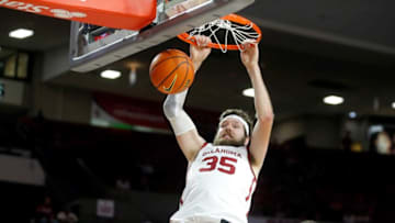 OU's Tanner Groves (35) dunks beside Northwestern State's Jordan Potts (13) on Tuesday.Ou Vs Northwestern State